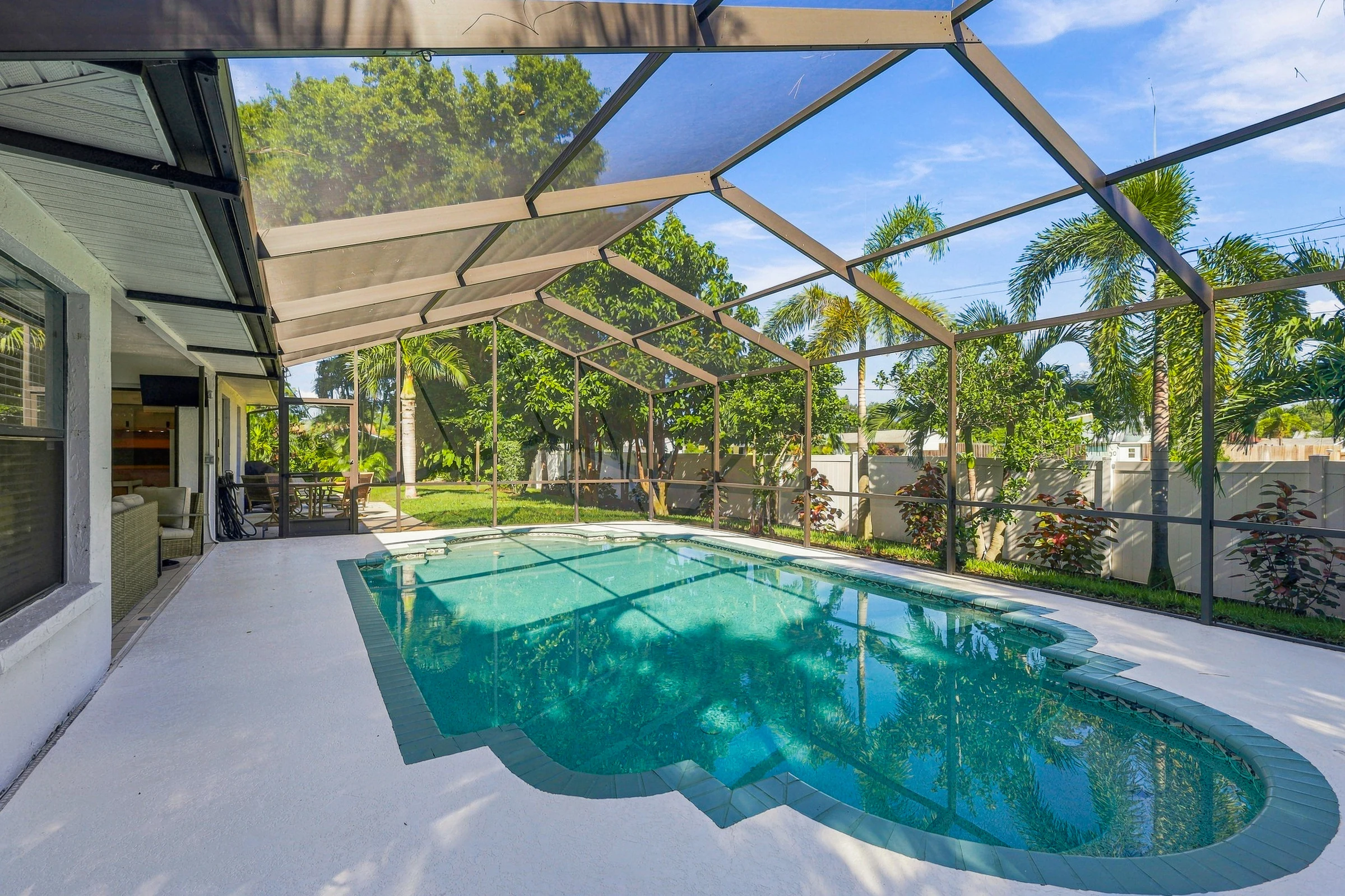 Sunlit screened pool and outdoor living photographed by Vuzario