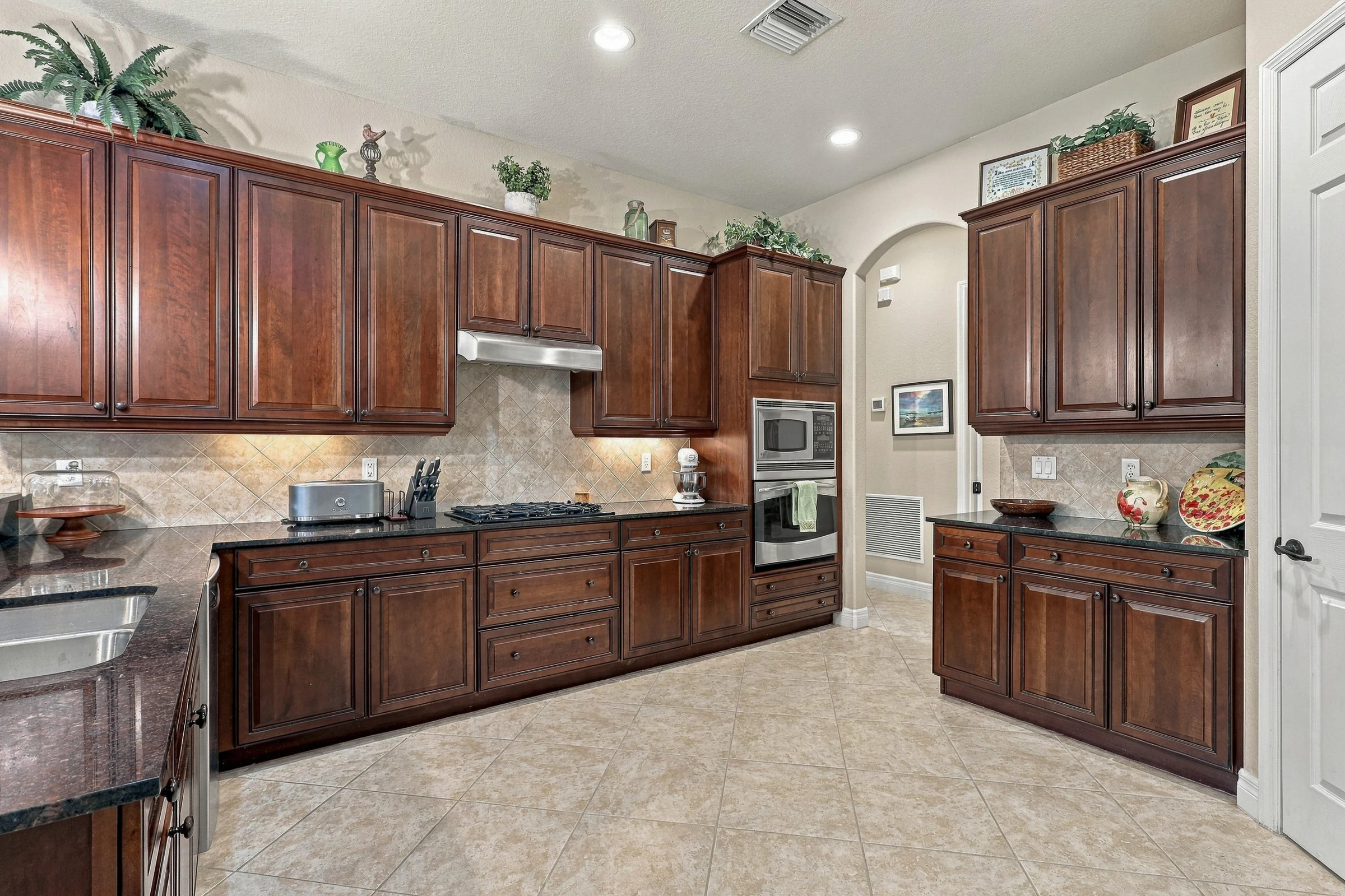 Warm wood kitchen cabinetry photographed by Vuzario