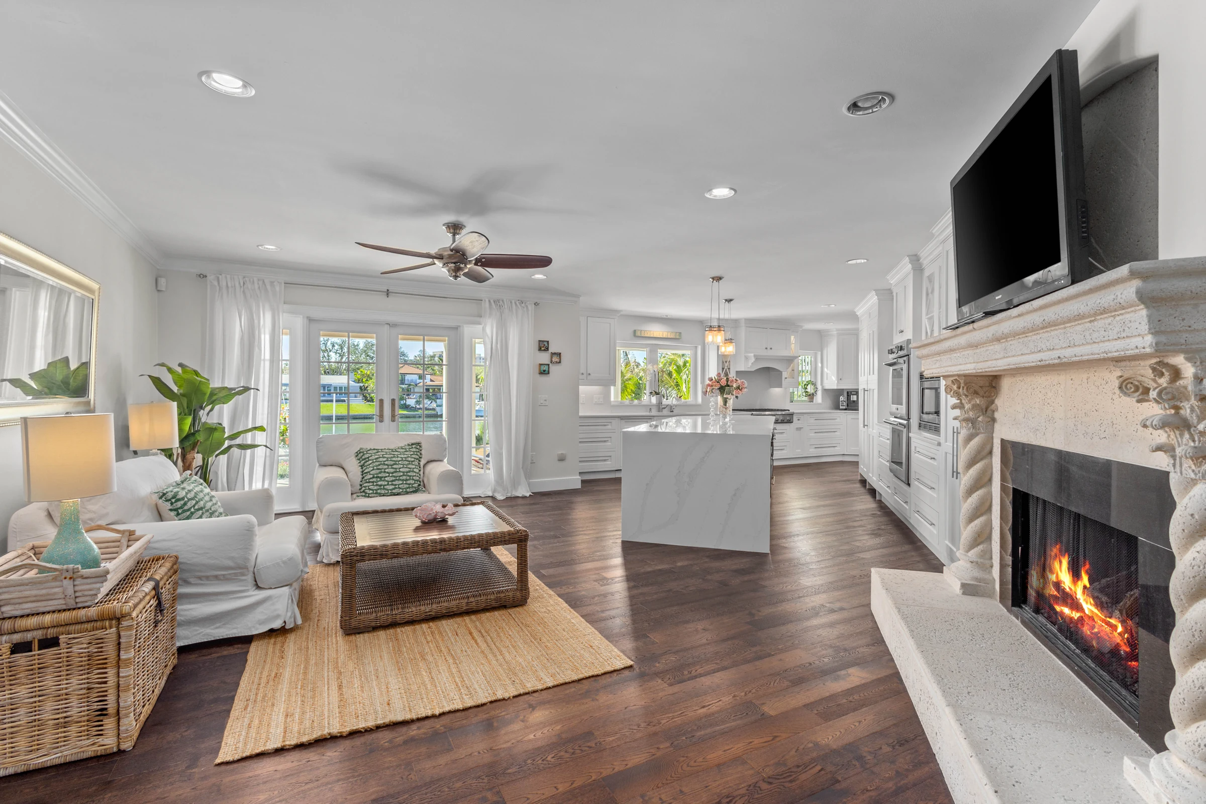 Waterfront family room and fireplace photographed by Vuzario