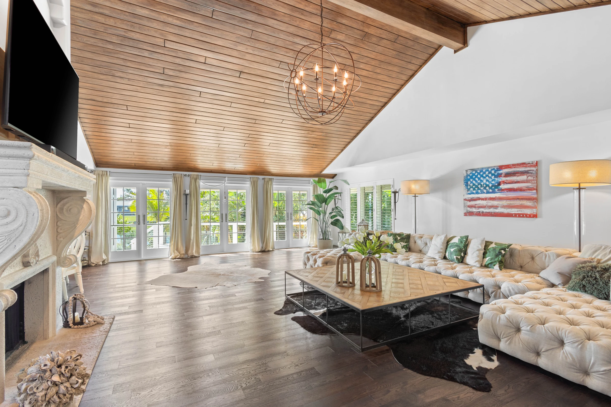 Great room with warm wood ceiling photographed by Vuzario