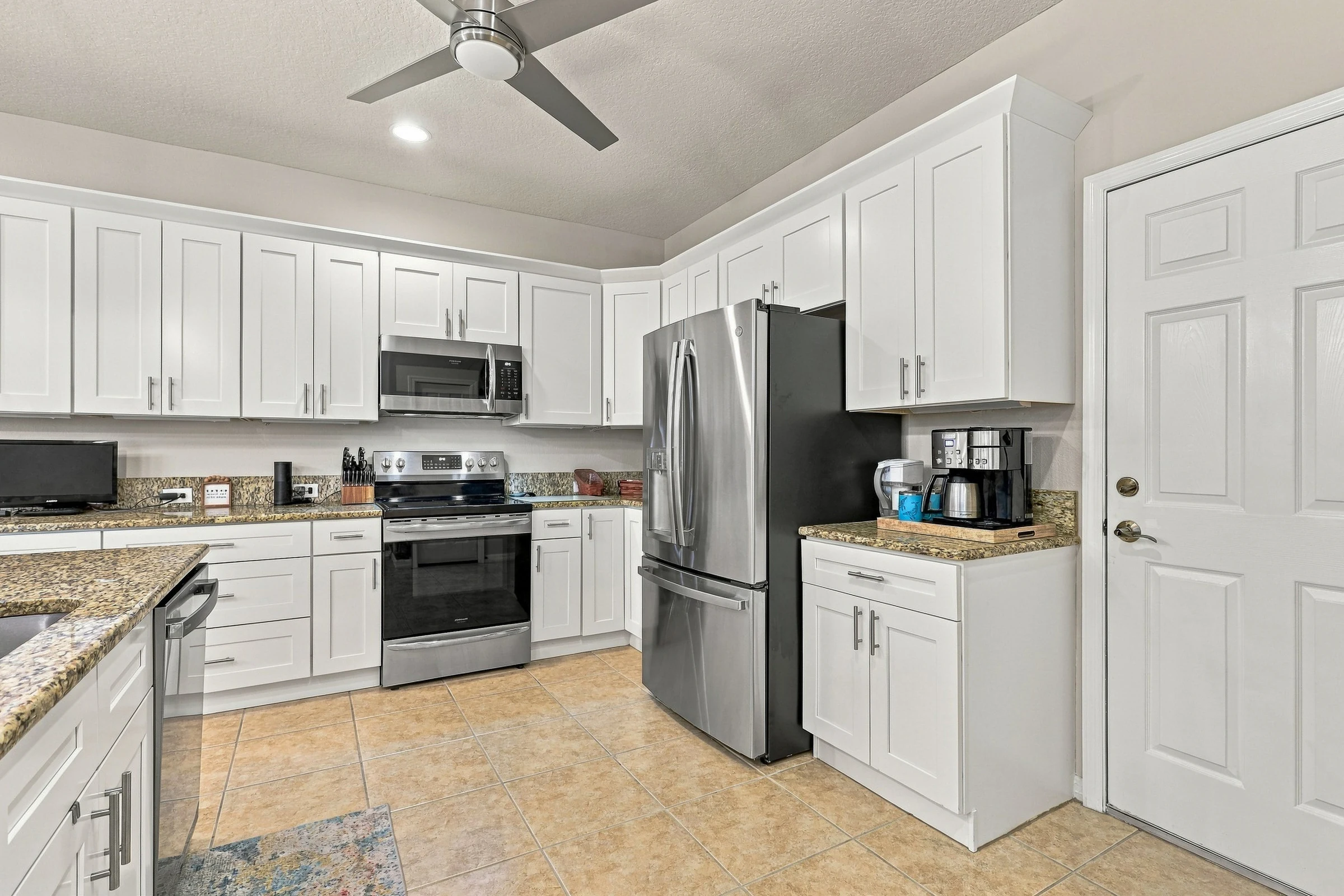 White kitchen and breakfast bar photographed by Vuzario
