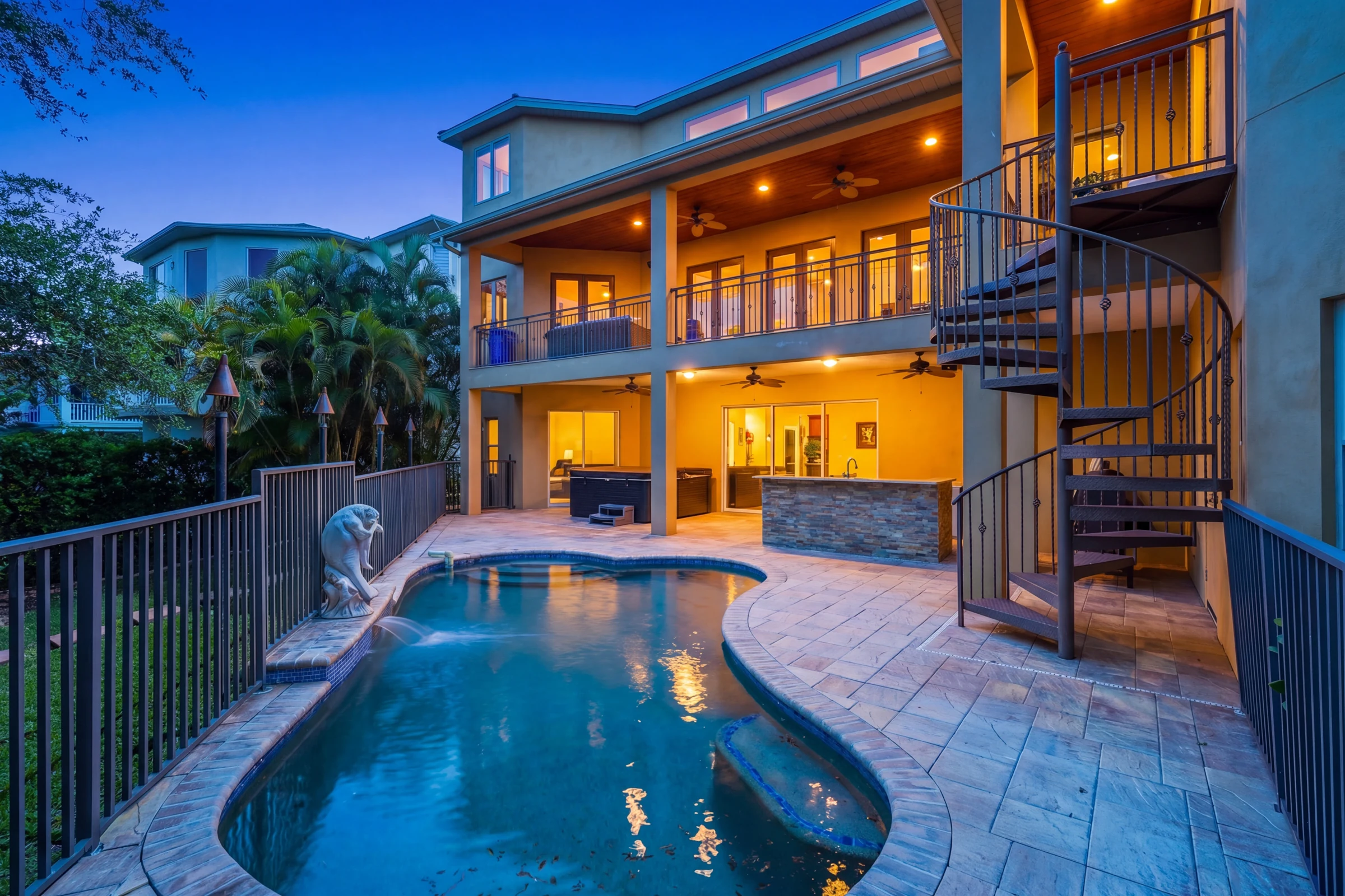 Pool and multi-level home at dusk photographed by Vuzario