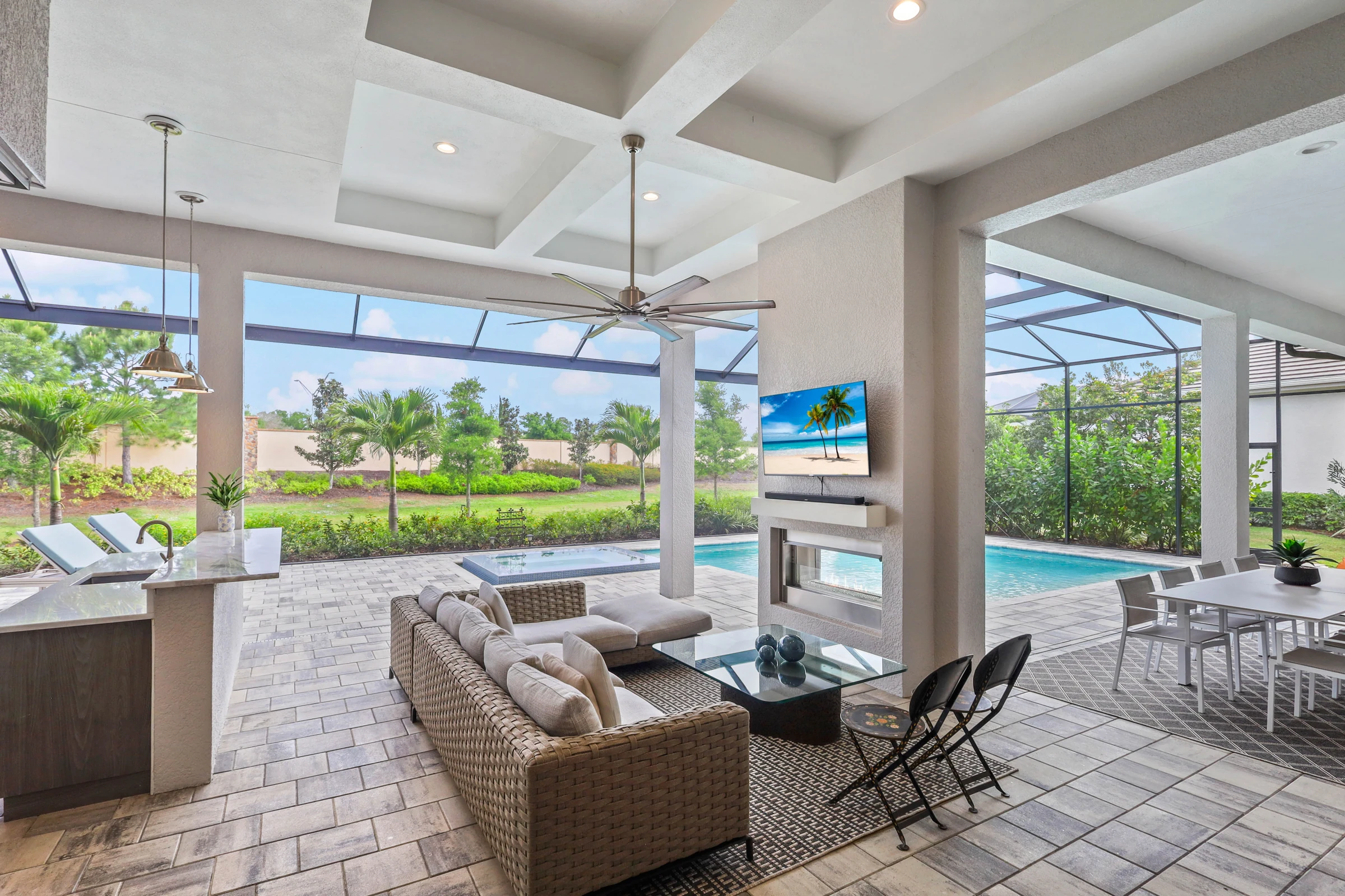 Covered living space beside the pool photographed by Vuzario