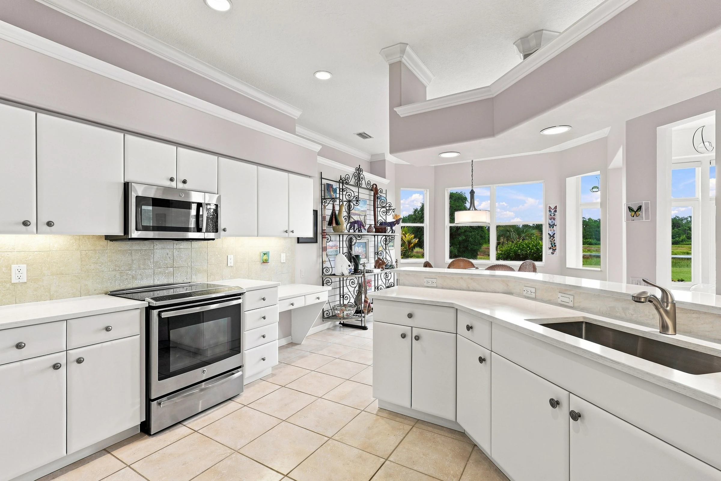 Bright white kitchen and garden outlook photographed by Vuzario